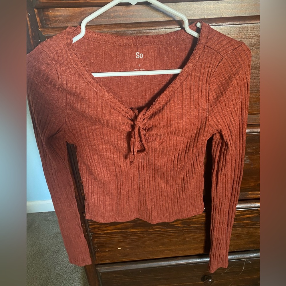 Long sleeve shirt. Tie in the front.